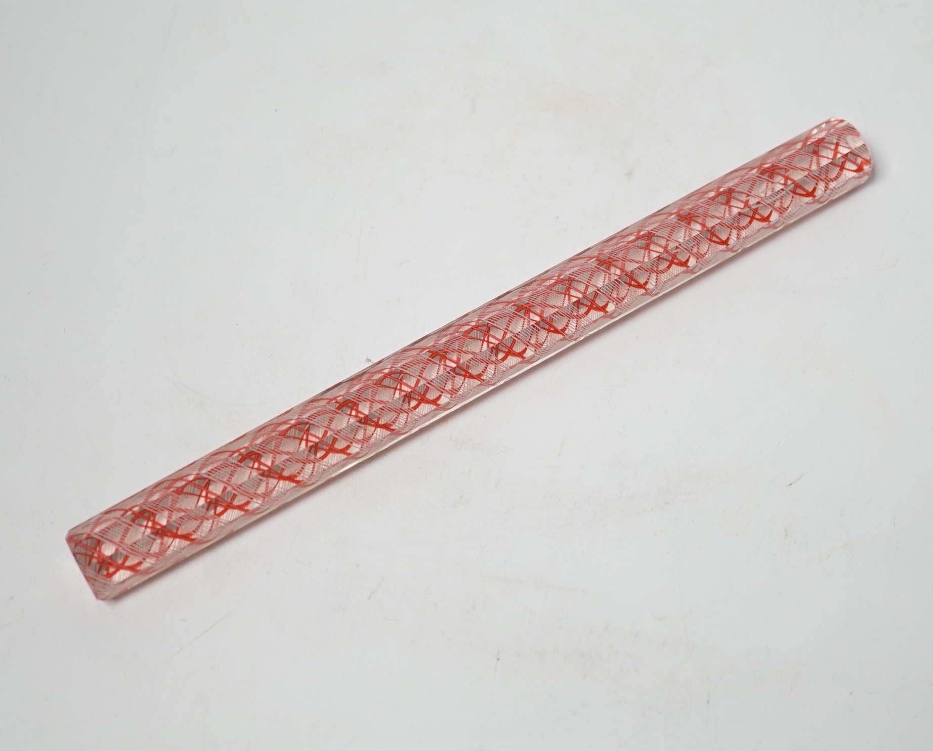 An octagonal glass colour twist rule, 24.5cm